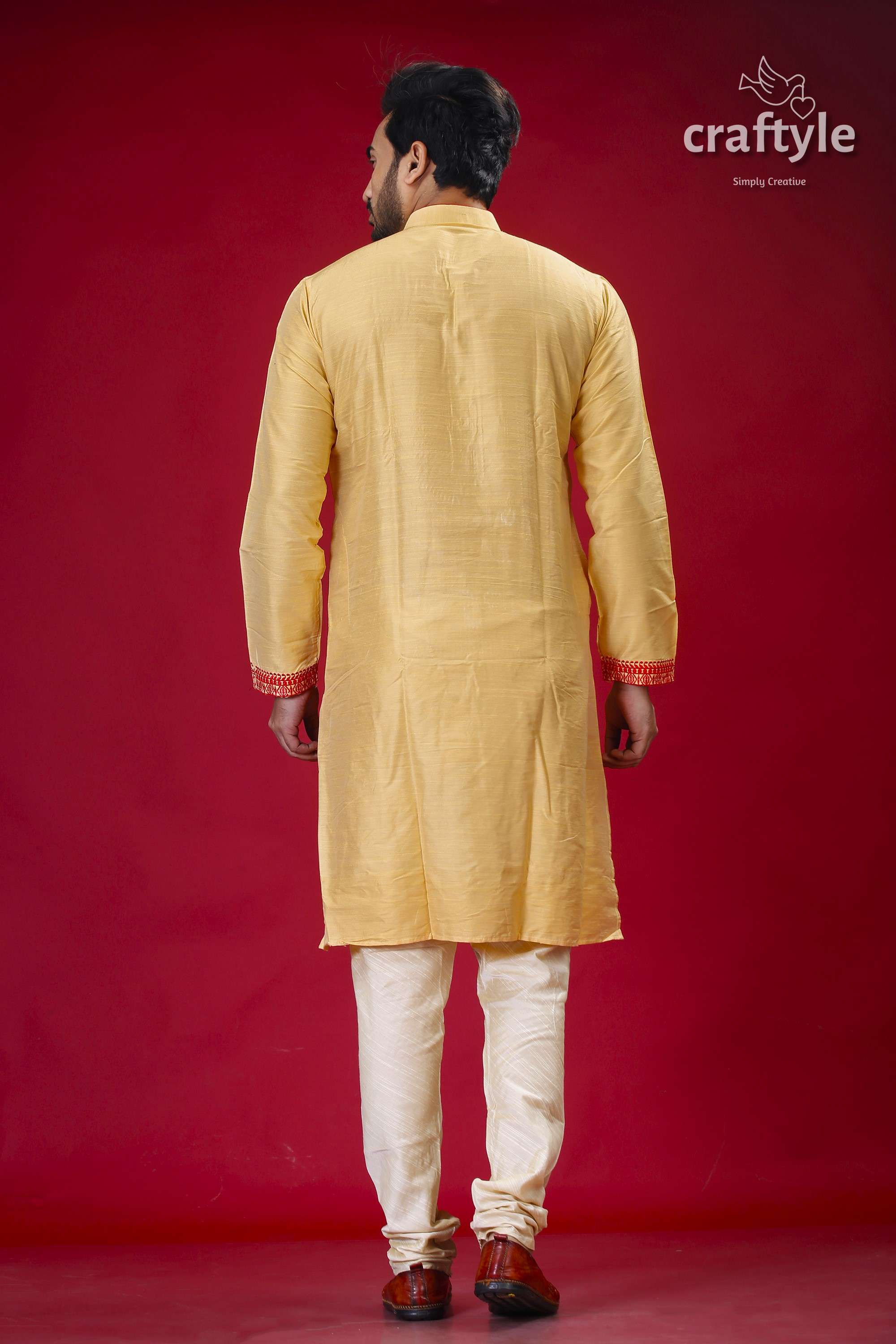 a man standing in front of a red background