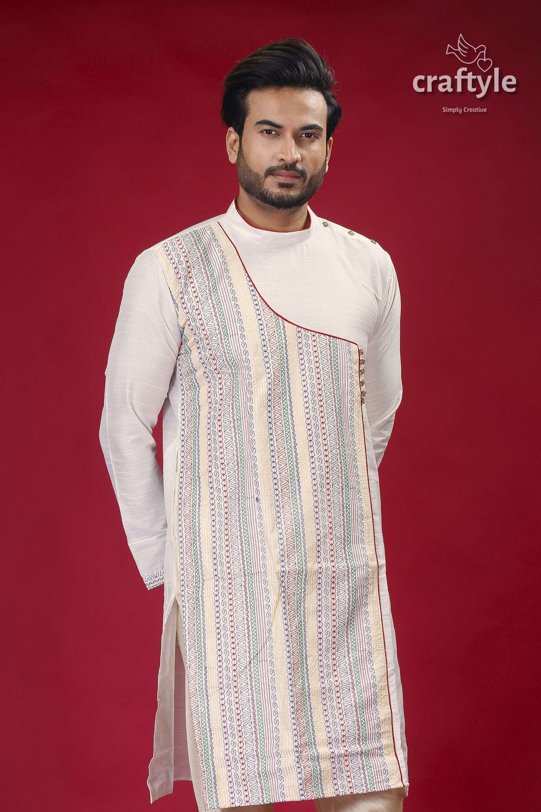 a man standing in front of a red background