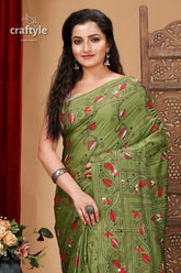 a woman in a green sari posing for a picture