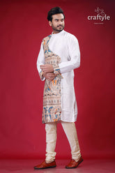 a man in a traditional indian outfit poses for a picture