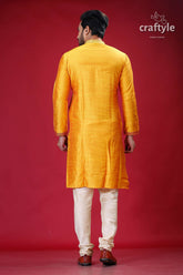 a man in a yellow indian outfit