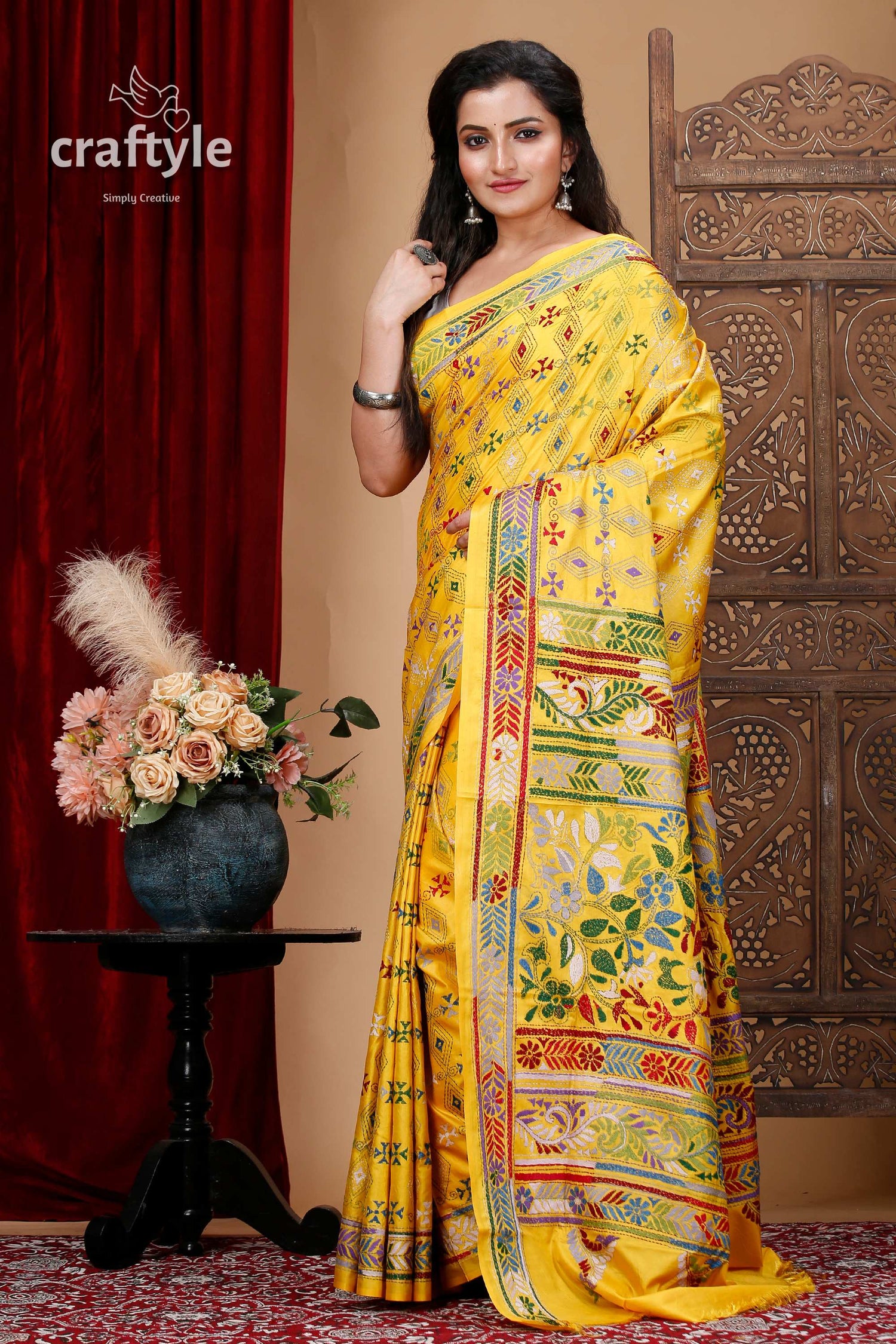 a woman in a yellow sari posing for a picture