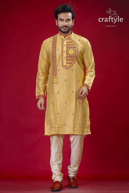 a man in a yellow outfit standing in front of a red background