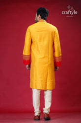 a man in a yellow and red indian outfit