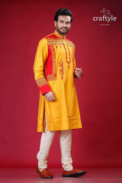 a man in a yellow and red indian outfit