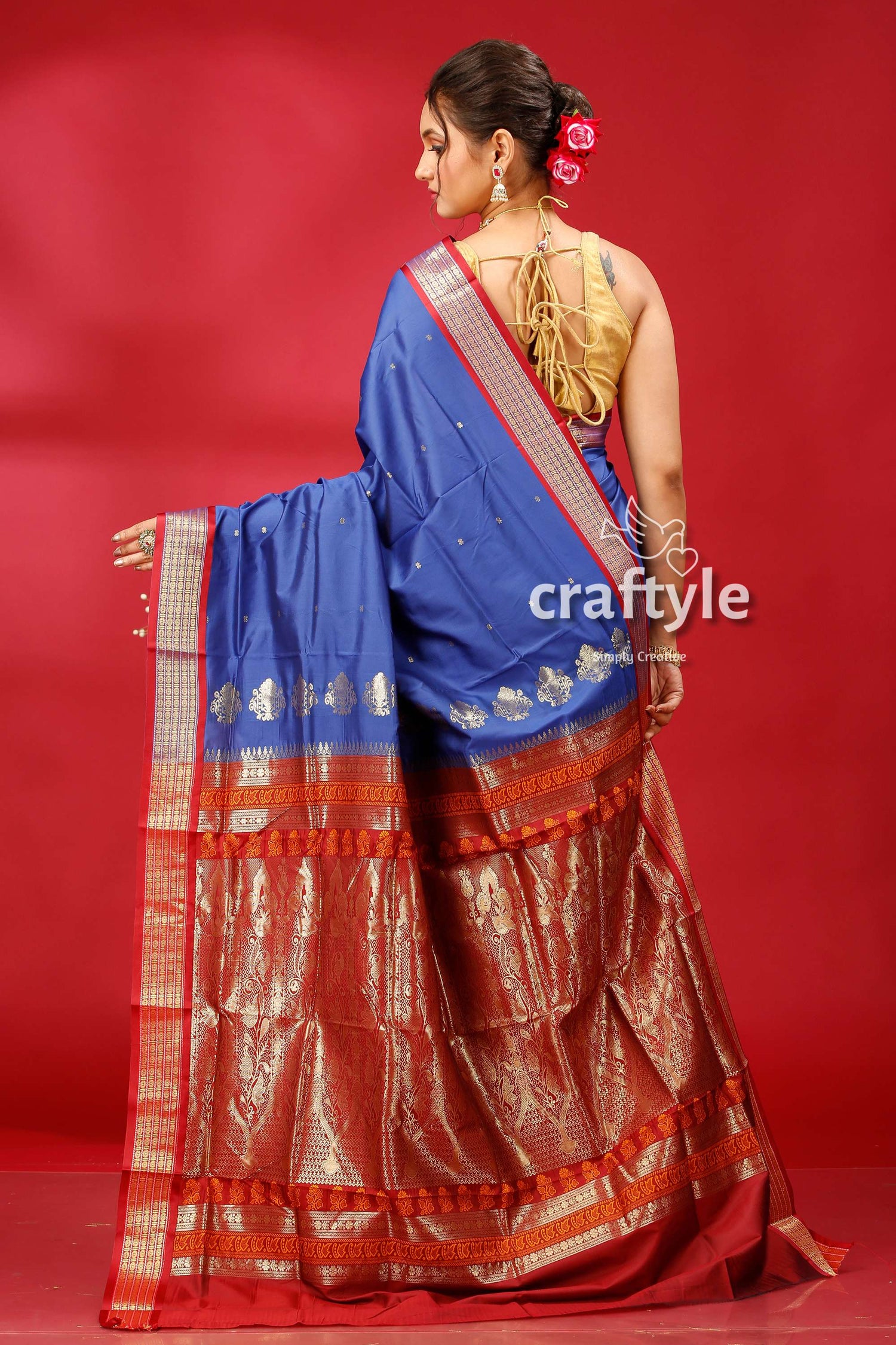 a woman in a blue and red sari