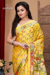 a woman in a yellow sari