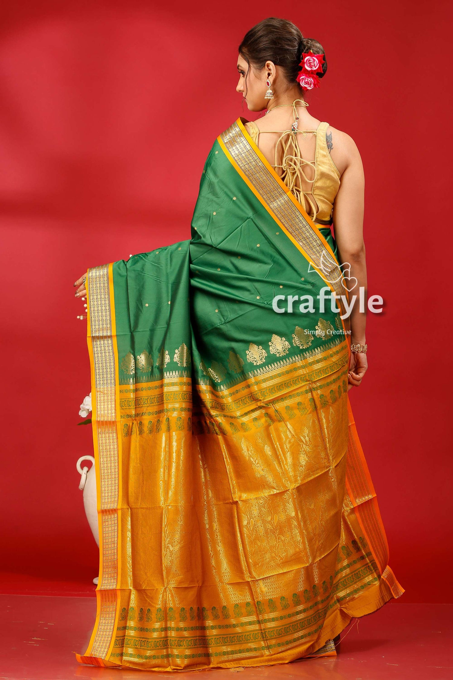 a woman in a green and yellow sari