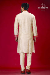 a man in a white sherwa with a red background