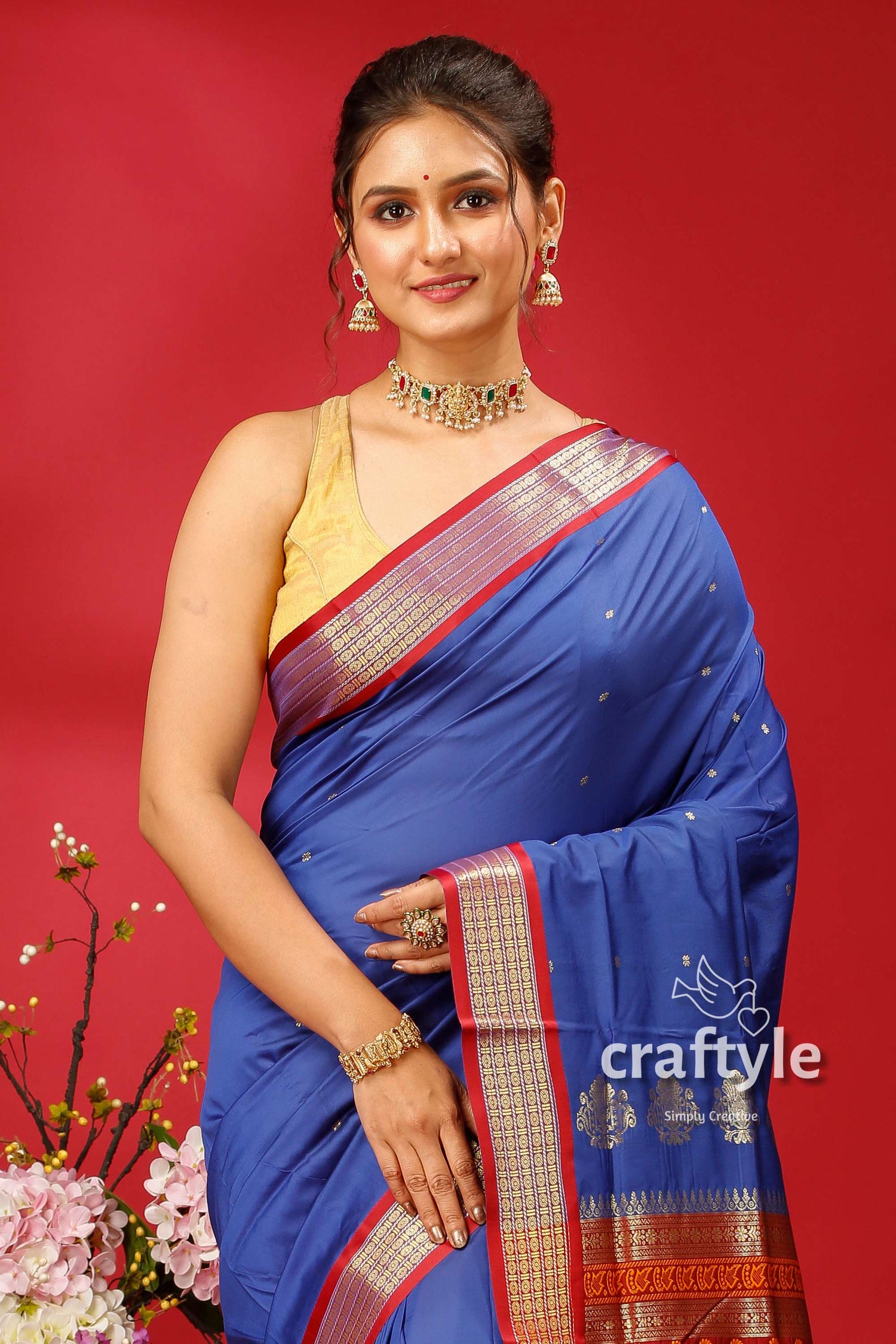 a woman in a blue sari posing for a picture