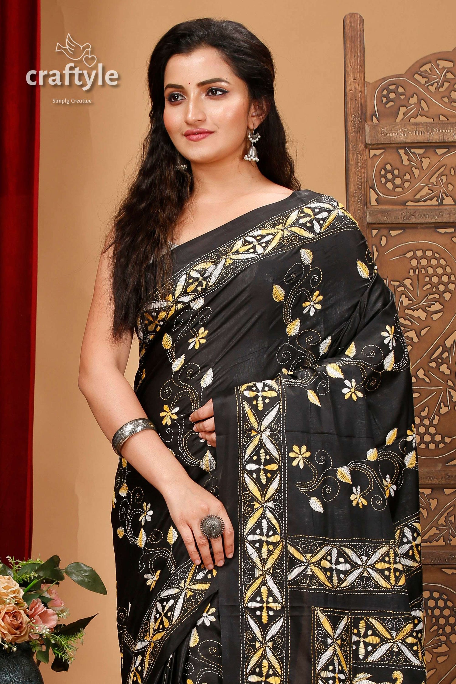 a woman in a black and gold sari