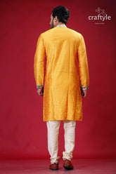 a man in a yellow indian outfit