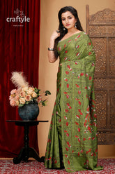 a woman in a green sari posing for a picture