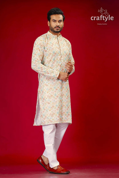 a man in a white outfit standing on a red background