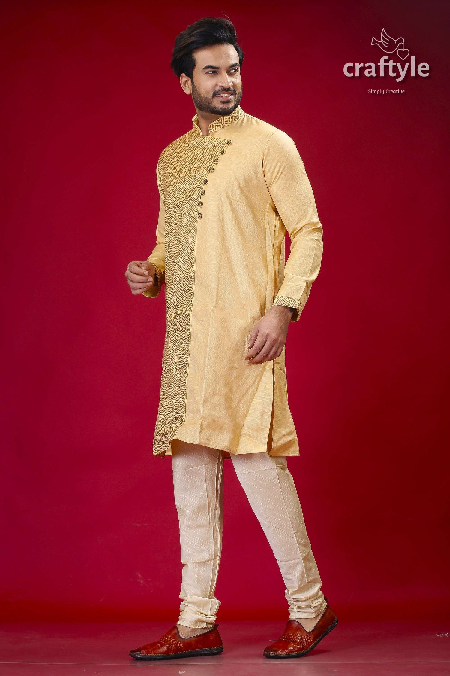 a man in a yellow outfit standing in front of a red background