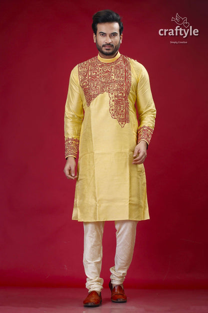 a man in a yellow outfit standing in front of a red background