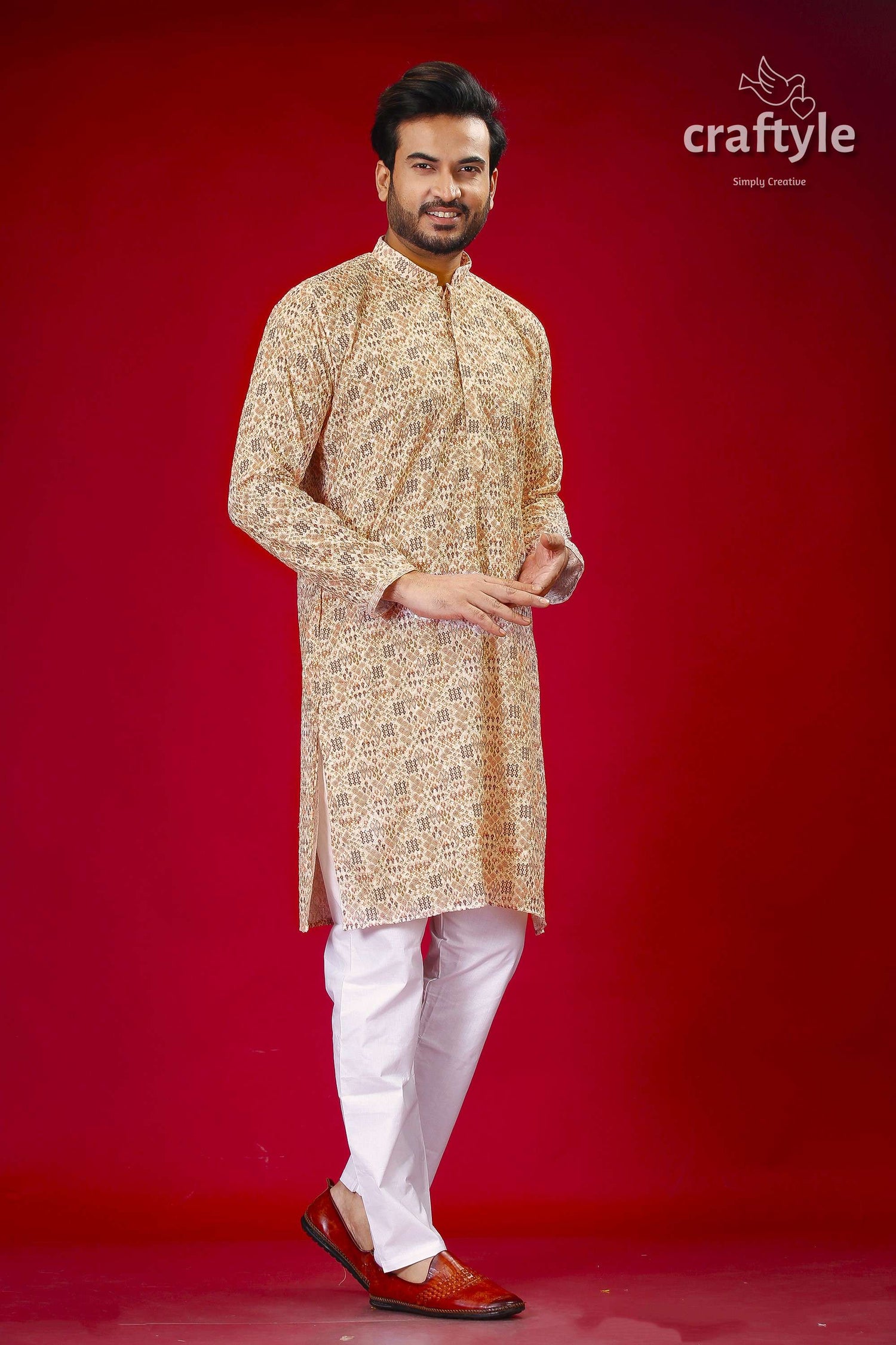 a man in a traditional indian outfit posing for a picture