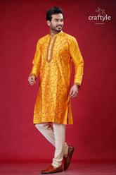 a man in a yellow outfit standing on a red background