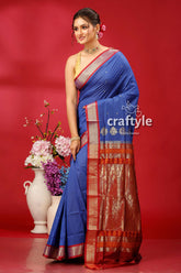 a woman in a blue and gold sari