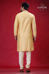 a man in a yellow sherwa with white pants