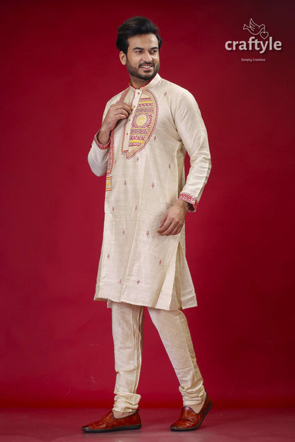 a man in a traditional indian outfit poses for a picture